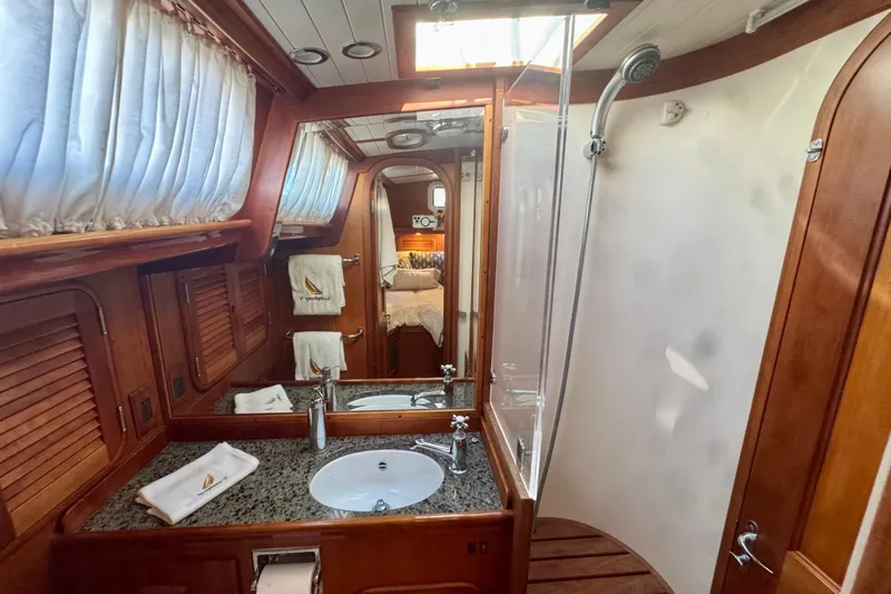 Symphony V Yacht Photos Pics Luxurious 1999 Hinckley Sou'wester 52 yacht bathroom with wood accents and modern fixtures.