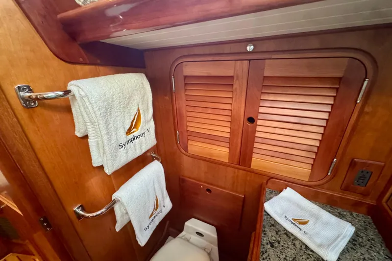 Symphony V Yacht Photos Pics Hinckley Sou'wester 52 yacht bathroom with wooden cabinets and embroidered towels, 1999 model.