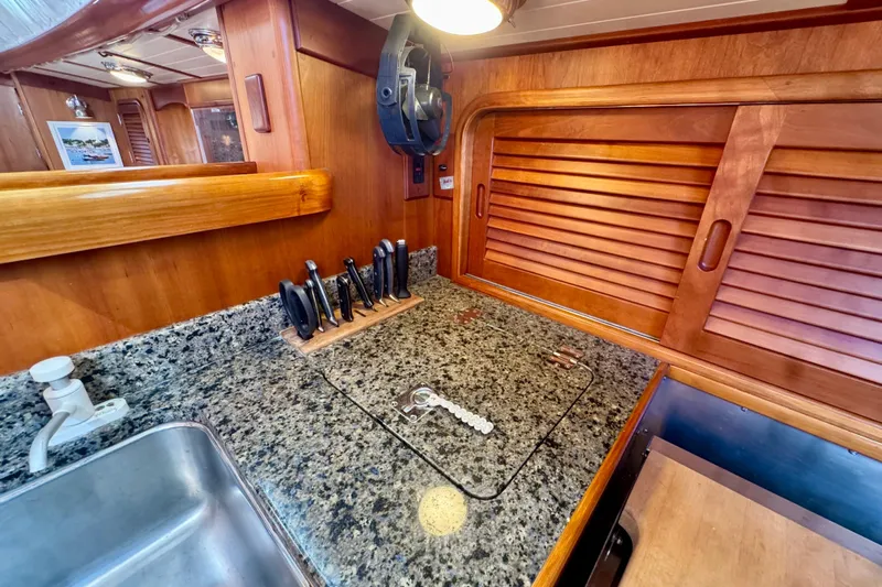 Symphony V Yacht Photos Pics Hinckley Sou'wester 52 yacht kitchen with granite countertop and wooden cabinetry, 1999 model.
