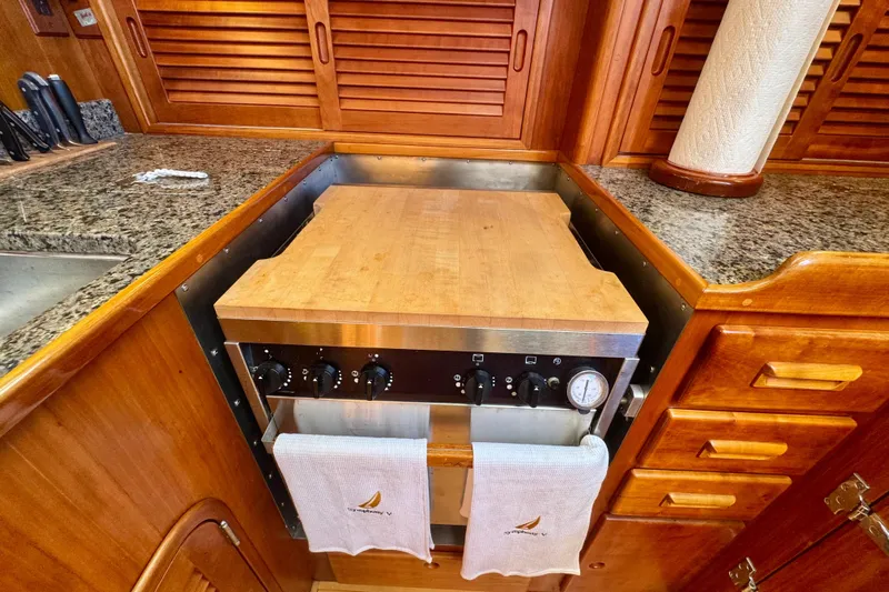 Symphony V Yacht Photos Pics Hinckley Sou'wester 52 yacht kitchen with wooden cabinetry and granite countertops, 1999 model.