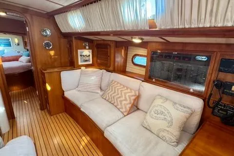 Symphony V Yacht Photos Pics Luxurious 1999 Hinckley Sou'wester 52 yacht interior with cozy seating and elegant wood finish.