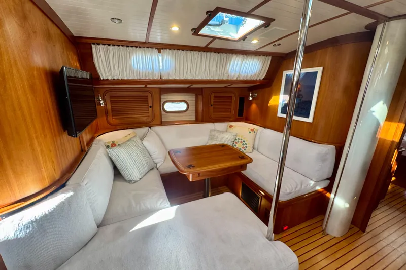 Symphony V Yacht Photos Pics Luxurious 1999 Hinckley Sou'wester 52 yacht interior with cozy seating and elegant wood finish.