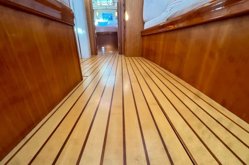 Symphony V Yacht Photos Pics Luxurious wooden interior of 1999 Hinckley Sou'wester 52 yacht, featuring elegant flooring.