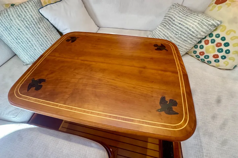 Symphony V Yacht Photos Pics Wooden table with bird inlays on a Hinckley Sou'wester 52 yacht, 1999 model.