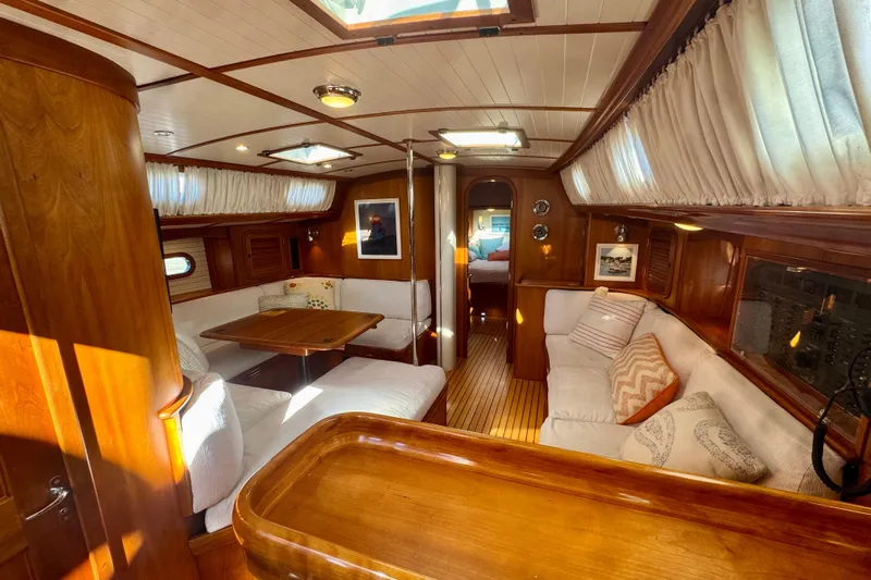 Symphony V Yacht Photos Pics Luxurious interior of a 1999 Hinckley Sou'wester 52 sailboat with elegant wood finishes.