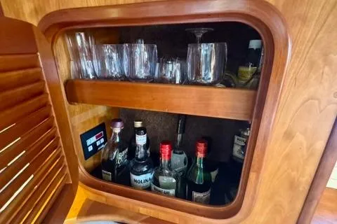 Symphony V Yacht Photos Pics Wooden cabinet with glassware and liquor bottles on a 1999 Hinckley Sou'wester 52 yacht.