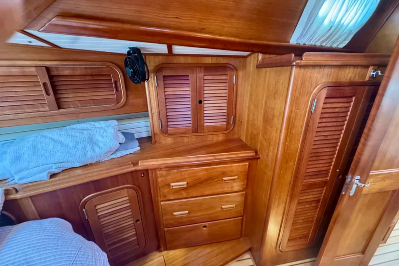 Symphony V Yacht Photos Pics Hinckley Sou'wester 52 yacht interior, featuring wooden cabinetry and storage, 1999 model.