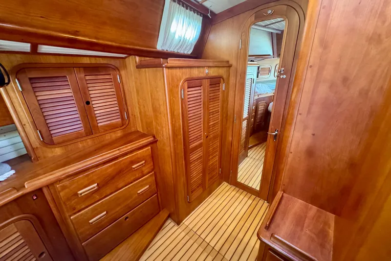 Symphony V Yacht Photos Pics Hinckley Sou'wester 52 yacht interior, featuring elegant wooden cabinetry and flooring, 1999 model.