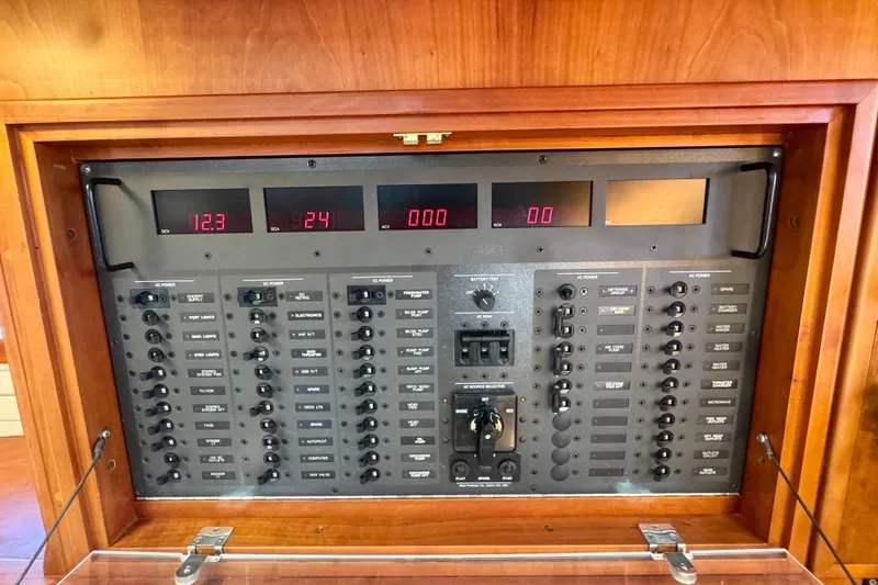 Symphony V Yacht Photos Pics Electrical control panel on a 1999 Hinckley Sou'wester 52 yacht, featuring digital displays and switches.