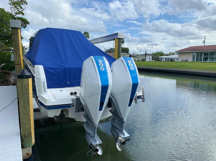  Yacht Photos Pics Hussar Skamander 920 Explorer MAX 2022 with dual outboard motors, docked and covered.