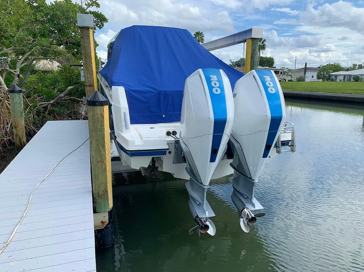  Yacht Photos Pics Hussar Skamander 920 Explorer MAX 2022 with twin outboard motors, docked and covered.