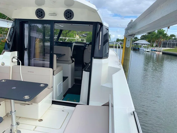  Yacht Photos Pics Hussar Skamander 920 Explorer MAX 2022 boat interior by a scenic waterfront.