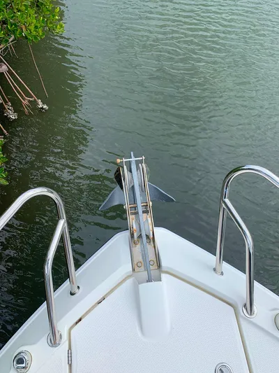  Yacht Photos Pics Bow of 2022 Parker Poland Hussar Skamander 920 Explorer MAX with anchor, near water and greenery.