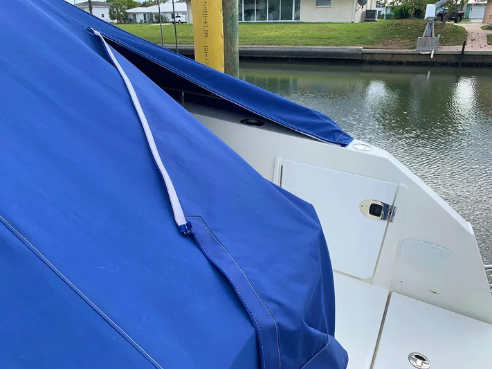  Yacht Photos Pics 2022 Parker Poland Hussar Skamander 920 Explorer MAX with blue cover by a canal.