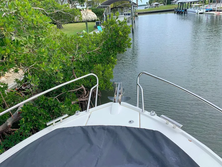  Yacht Photos Pics 2022 Parker Poland Hussar Skamander 920 Explorer MAX navigating a narrow waterway.