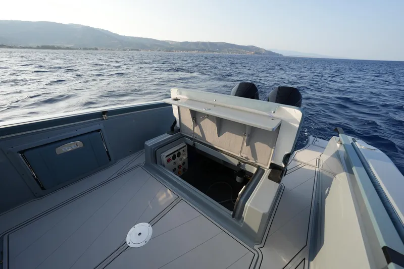  Yacht Photos Pics 2025 Ranieri Cayman 33 Executive boat interior with open storage compartment on the ocean.