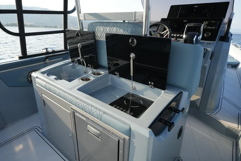  Yacht Photos Pics 2025 Ranieri Cayman 33 Executive yacht interior with modern kitchen and steering console.