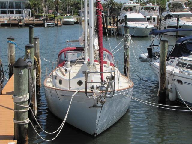 1974 Custom Lazy Jack 32 sailboat docked in a marina, surrounded by other boats.