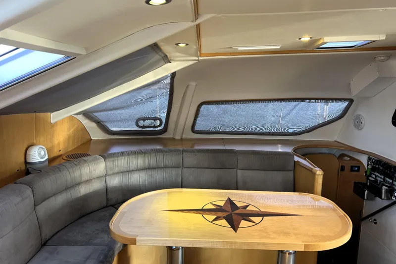 Evolution Yacht Photos Pics Luxurious interior of 2011 Privilege 495 yacht with elegant seating and wooden table.