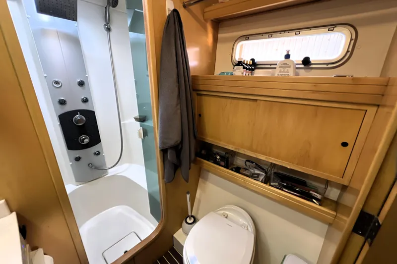 Evolution Yacht Photos Pics Luxurious 2011 Privilege 495 yacht bathroom with modern shower and wooden cabinetry.