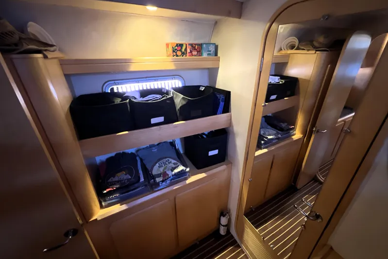 Evolution Yacht Photos Pics Interior of 2011 Privilege 495 yacht with organized storage shelves and wooden finish.