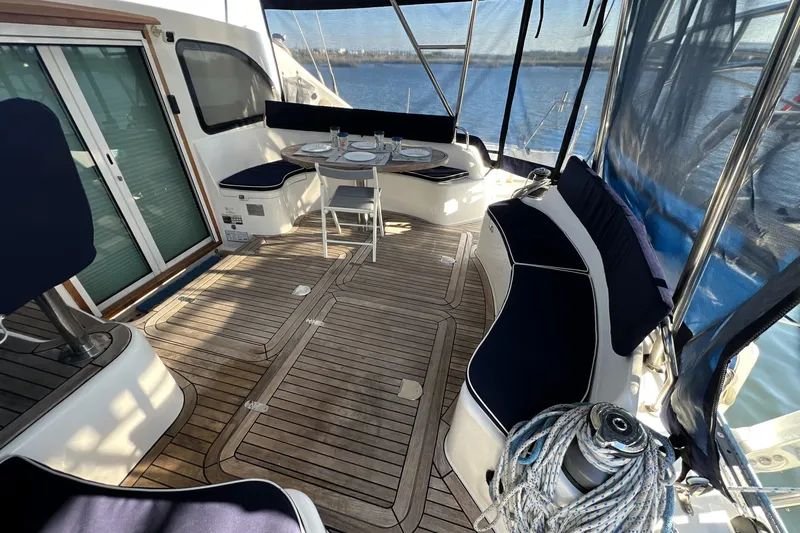 Evolution Yacht Photos Pics Spacious deck of 2011 Privilege 495 yacht with seating and dining area.