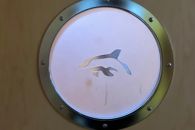 Evolution Yacht Photos Pics Porthole with dolphin design on Privilege 495 yacht, 2011 model.