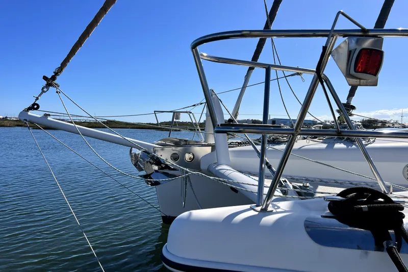 Evolution Yacht Photos Pics Sailing yacht Privilege 495, 2011 model, docked in calm waters under clear blue sky.