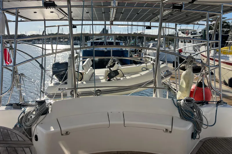 Evolution Yacht Photos Pics Sailboat Privilege 495, 2011 model, docked with solar panels and dinghy in marina.