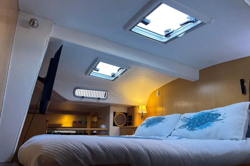 Evolution Yacht Photos Pics Luxurious cabin interior of 2011 Privilege 495 yacht with skylights and cozy bedding.