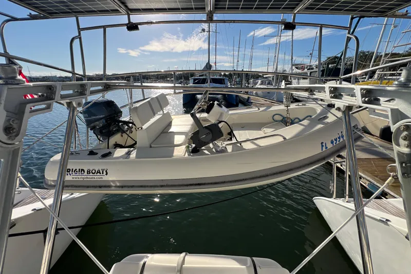 Evolution Yacht Photos Pics Sailboat with dinghy, Privilege 495, 2011 model, docked in marina under sunny sky.