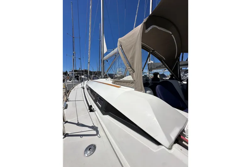 Jenni Yacht Photos Pics 2015 Jeanneau Sun Odyssey 409 sailboat deck with canopy, docked in marina.