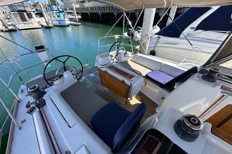 Jenni Yacht Photos Pics 2015 Jeanneau Sun Odyssey 409 sailboat cockpit with dual steering wheels, docked in a marina.