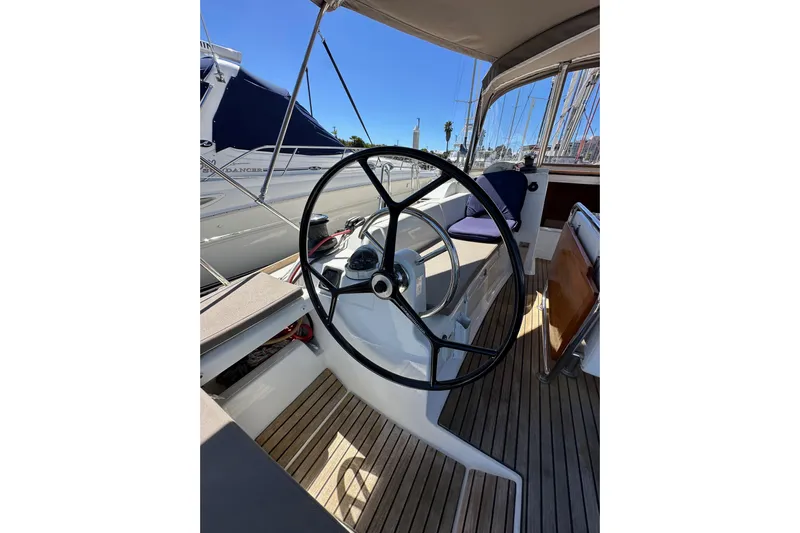 Jenni Yacht Photos Pics Steering wheel of 2015 Jeanneau Sun Odyssey 409 sailboat, docked in marina.