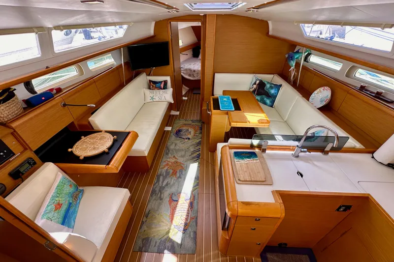 Jenni Yacht Photos Pics Interior of 2015 Jeanneau Sun Odyssey 409 yacht with cozy seating and modern amenities.