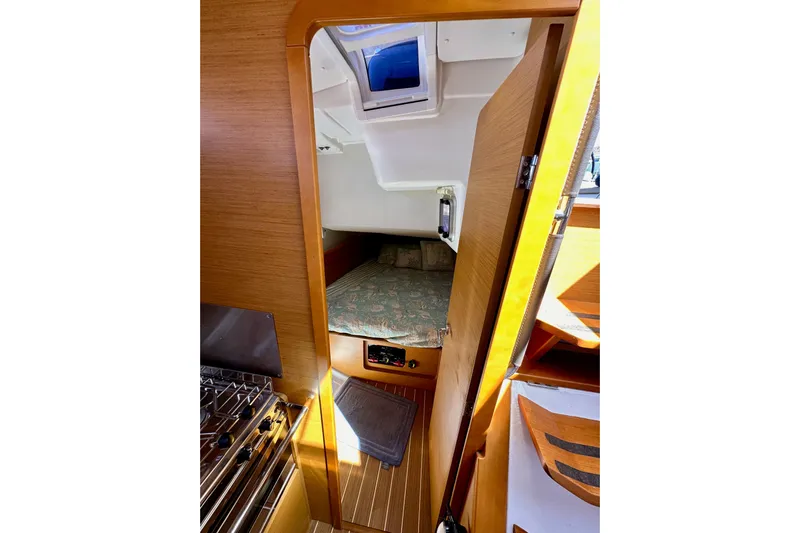 Jenni Yacht Photos Pics Interior cabin view of 2015 Jeanneau Sun Odyssey 409 sailboat, featuring cozy sleeping area.