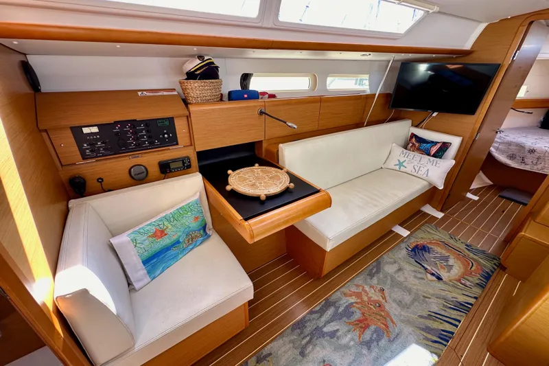 Jenni Yacht Photos Pics Luxurious interior of 2015 Jeanneau Sun Odyssey 409 yacht with cozy seating and nautical decor.