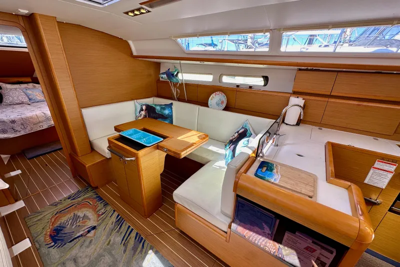 Jenni Yacht Photos Pics Interior of 2015 Jeanneau Sun Odyssey 409 sailboat with cozy seating and modern design.