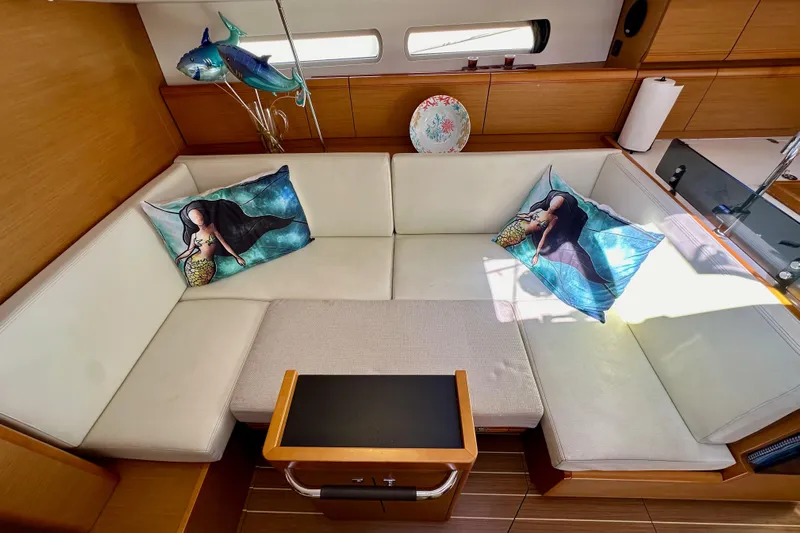 Jenni Yacht Photos Pics Cozy interior of 2015 Jeanneau Sun Odyssey 409 with mermaid-themed pillows and elegant decor.