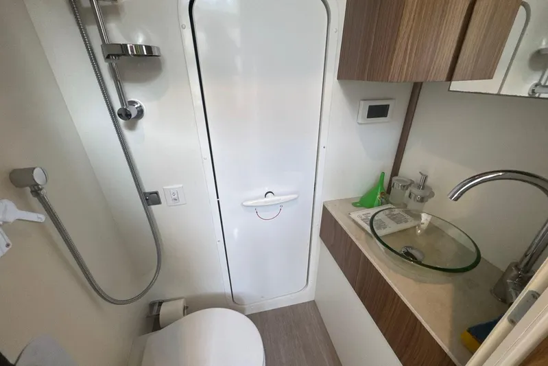  Yacht Photos Pics Bathroom interior of 2017 Absolute 60 Fly yacht with modern fixtures and glass sink.