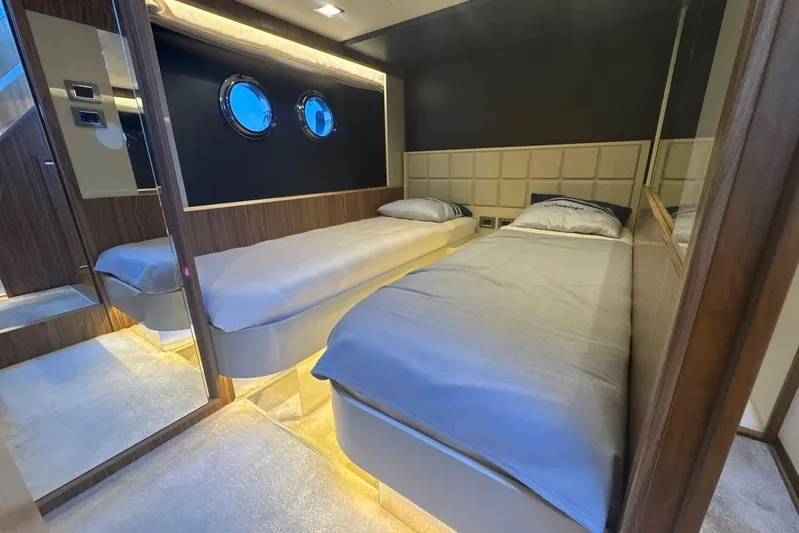  Yacht Photos Pics Luxurious twin bedroom on 2017 Absolute 60 Fly yacht with modern decor and porthole windows.