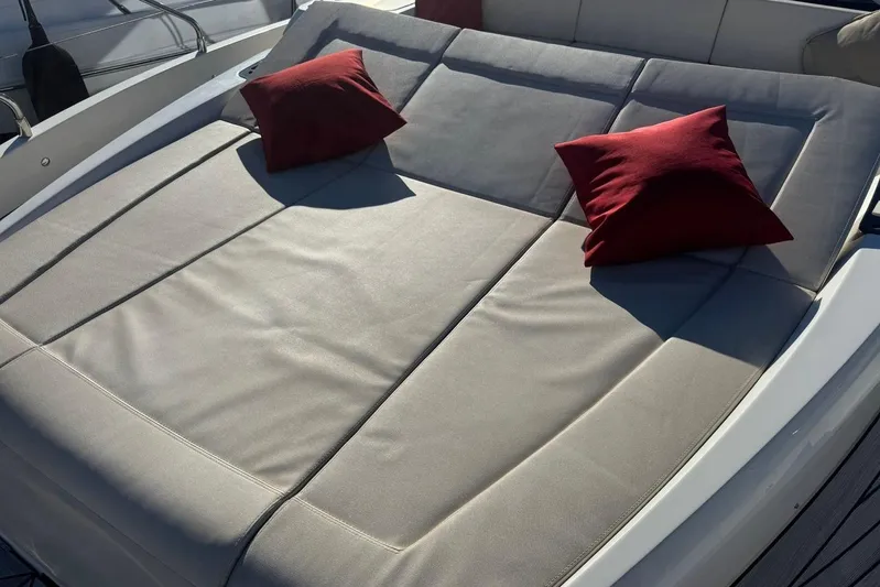  Yacht Photos Pics Luxurious sunbed with red cushions on a 2017 Absolute 60 Fly yacht.