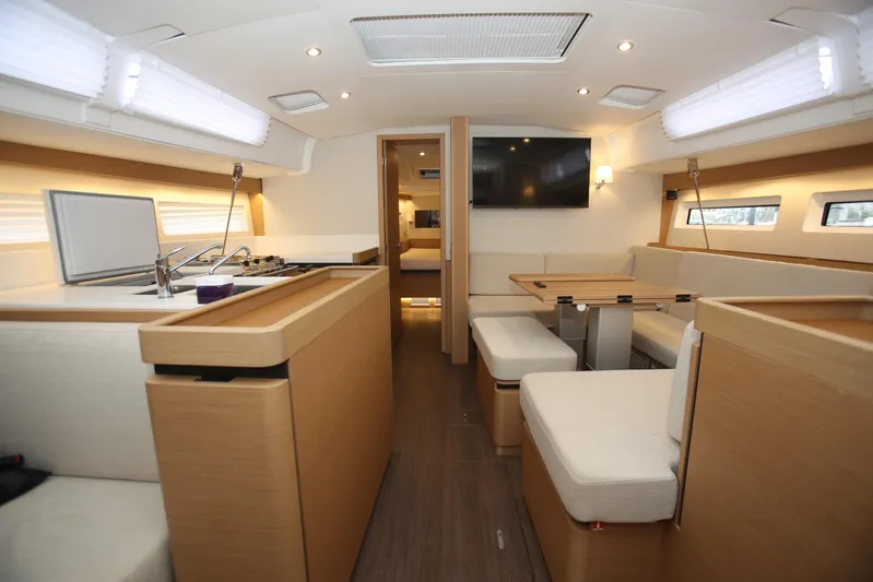 Valinore Yacht Photos Pics Interior of 2023 Jeanneau Sun Odyssey 490 yacht, featuring modern kitchen and seating area.