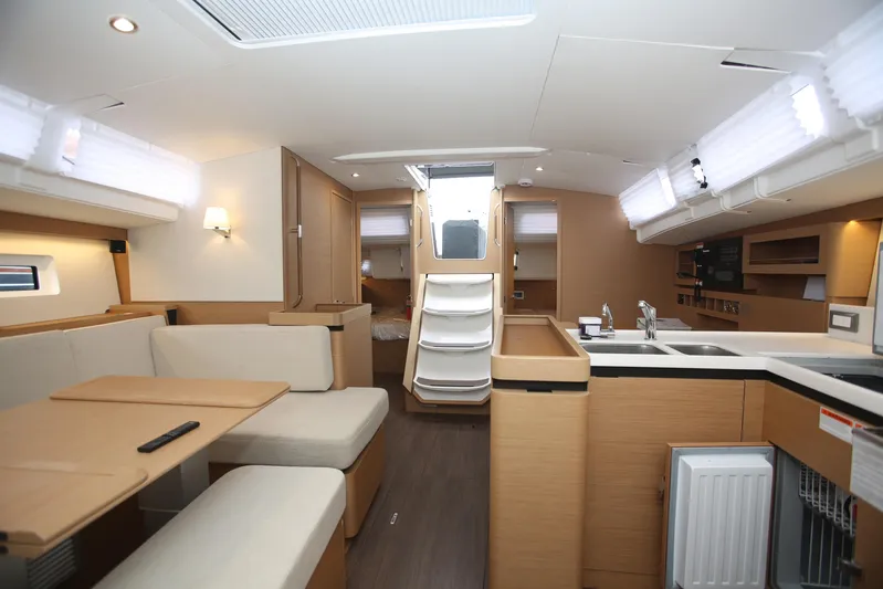 Valinore Yacht Photos Pics Interior of 2023 Jeanneau Sun Odyssey 490 yacht, featuring modern kitchen and seating area.