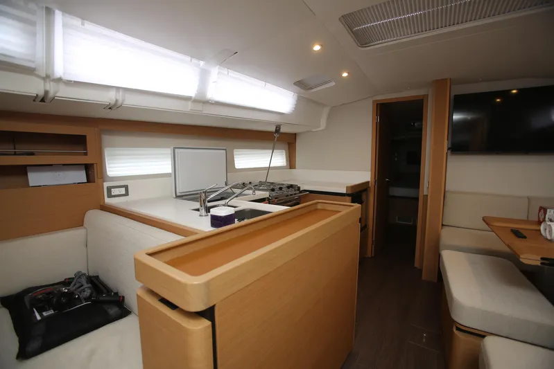 Valinore Yacht Photos Pics Interior of 2023 Jeanneau Sun Odyssey 490 yacht, featuring modern kitchen and seating area.
