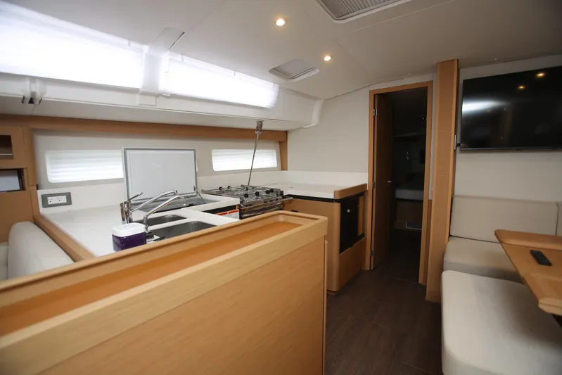 Valinore Yacht Photos Pics Interior of 2023 Jeanneau Sun Odyssey 490 yacht, featuring modern kitchen and seating area.