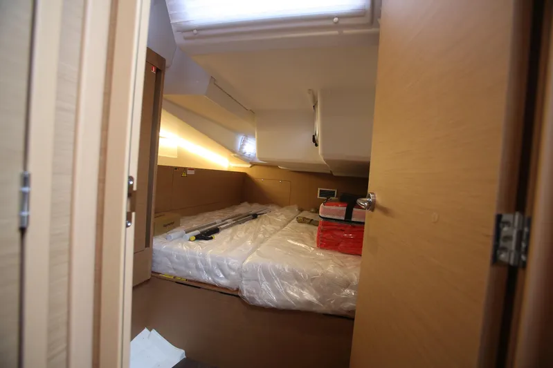 Valinore Yacht Photos Pics Interior cabin of 2023 Jeanneau Sun Odyssey 490 yacht, featuring modern design and storage.