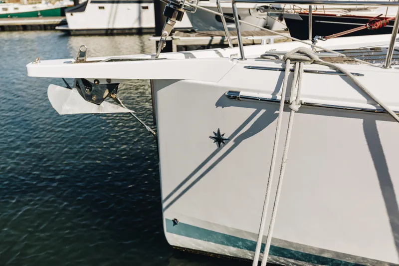 Valinore Yacht Photos Pics Jeanneau Sun Odyssey 490 yacht, 2023 model, docked with anchor and ropes visible.