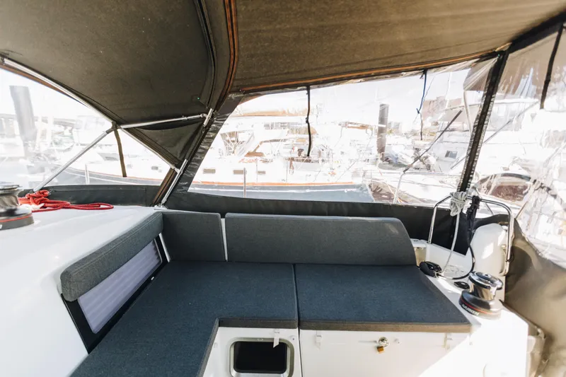 Valinore Yacht Photos Pics 2023 Jeanneau Sun Odyssey 490 cockpit with cushioned seating and protective canopy.
