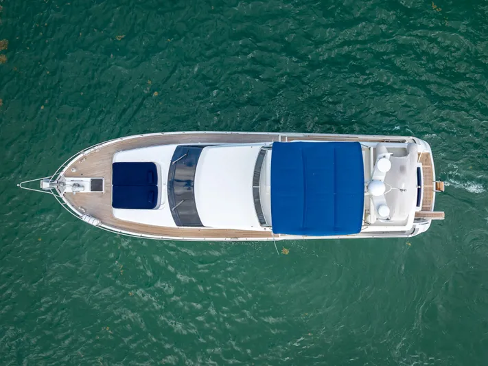 Bramamare Yacht Photos Pics Aerial view of 1995 Sanlorenzo 62 yacht on turquoise water.